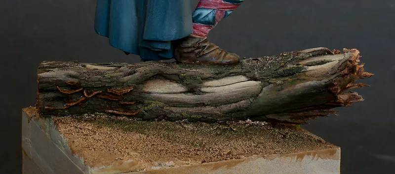 Photo of moss and mushroom on the fallen log on the scenic base for Viking Chef - Minichix Studio tutorial on building miniature bases.