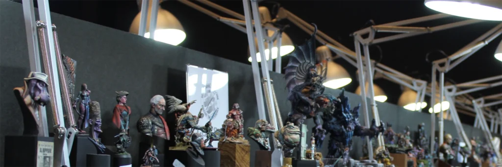 photo of miniatures standing under bright lights at the miniature painting competition - made for Minichix Studio article.